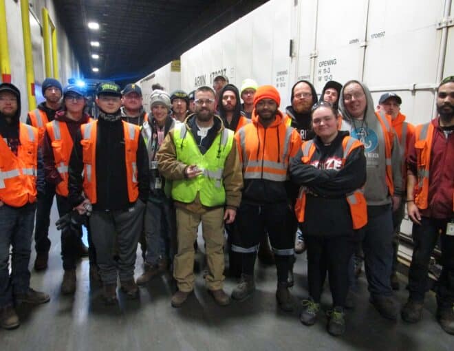 capstone staff members holding award