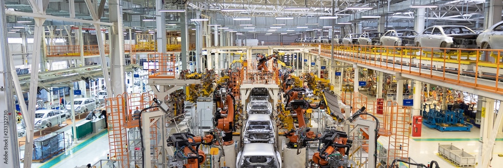 cars being built inside a factory