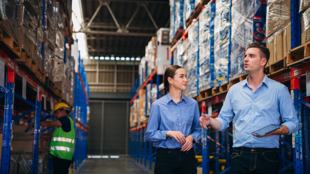 Warehouse worker working and checking the stock in the warehouse. Factory manager using digital tablet check barcode in industry factory logistic.