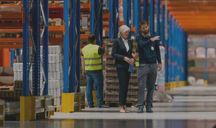 businesspeople talking inside warehouse