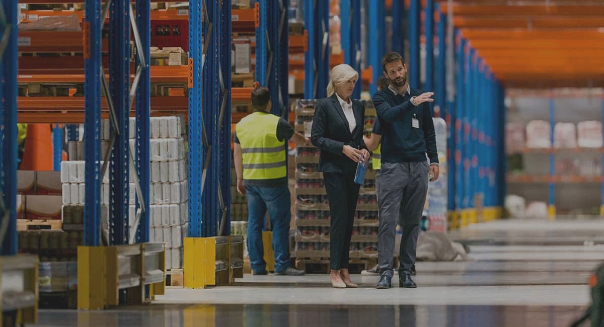 businesspeople talking inside warehouse