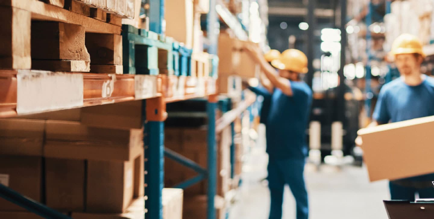 warehouse workers moving boxes from shelving