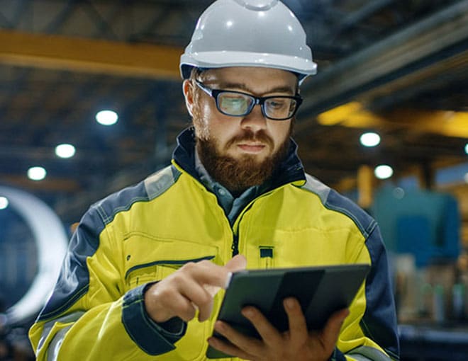 man looking at tablet in warehouse