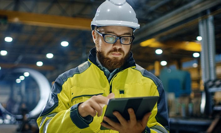 man looking at tablet in warehouse