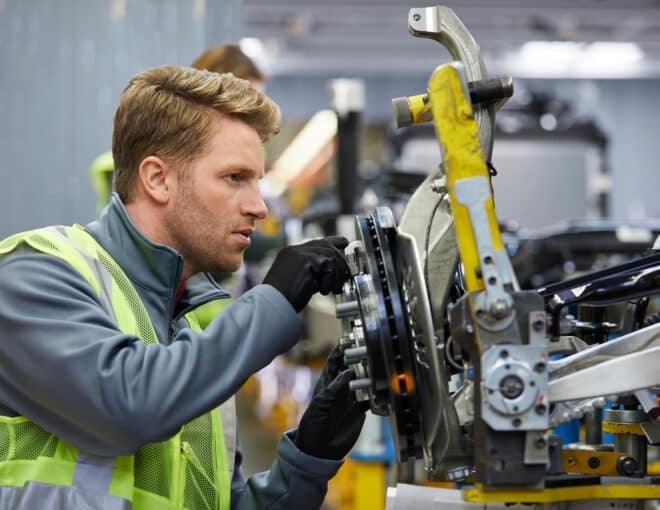 Automotive Worker adjusting brakes