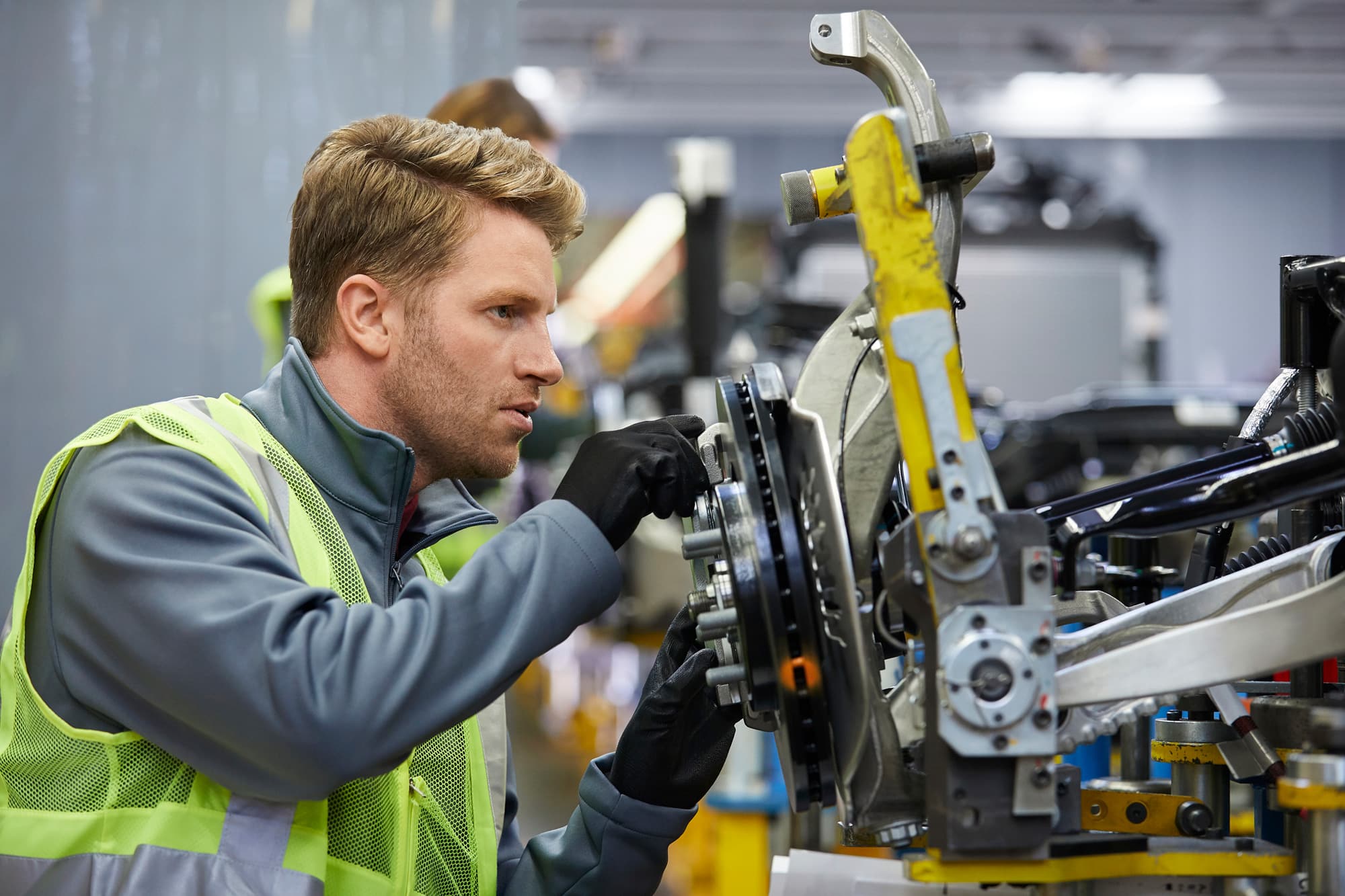 Automotive Worker adjusting brakes
