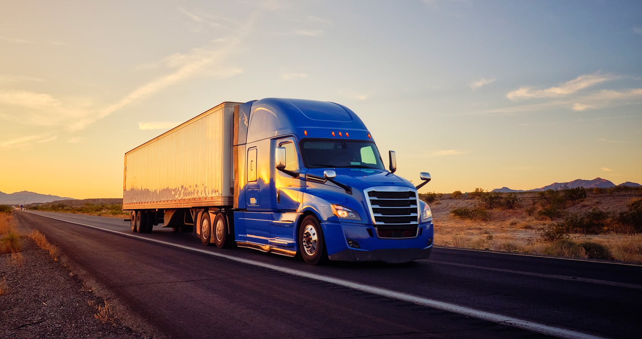 semi truck driving down country road