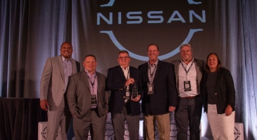 capstone workers holding Nissan supplier award