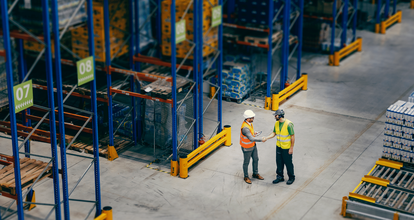 two workers talking in warehouse