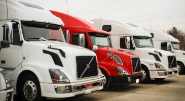 semi trucks parked side by side