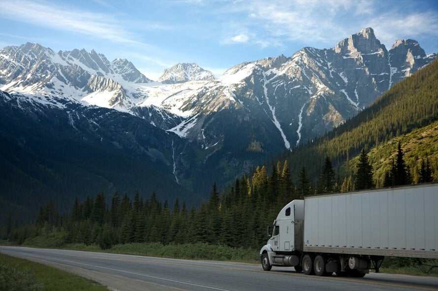 semi truck driving in the mountains
