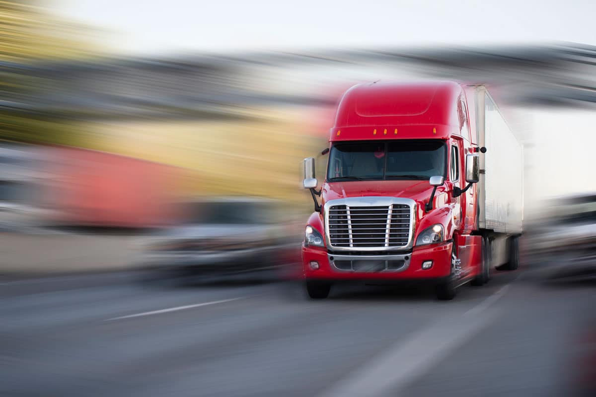 truck driving quickly on road