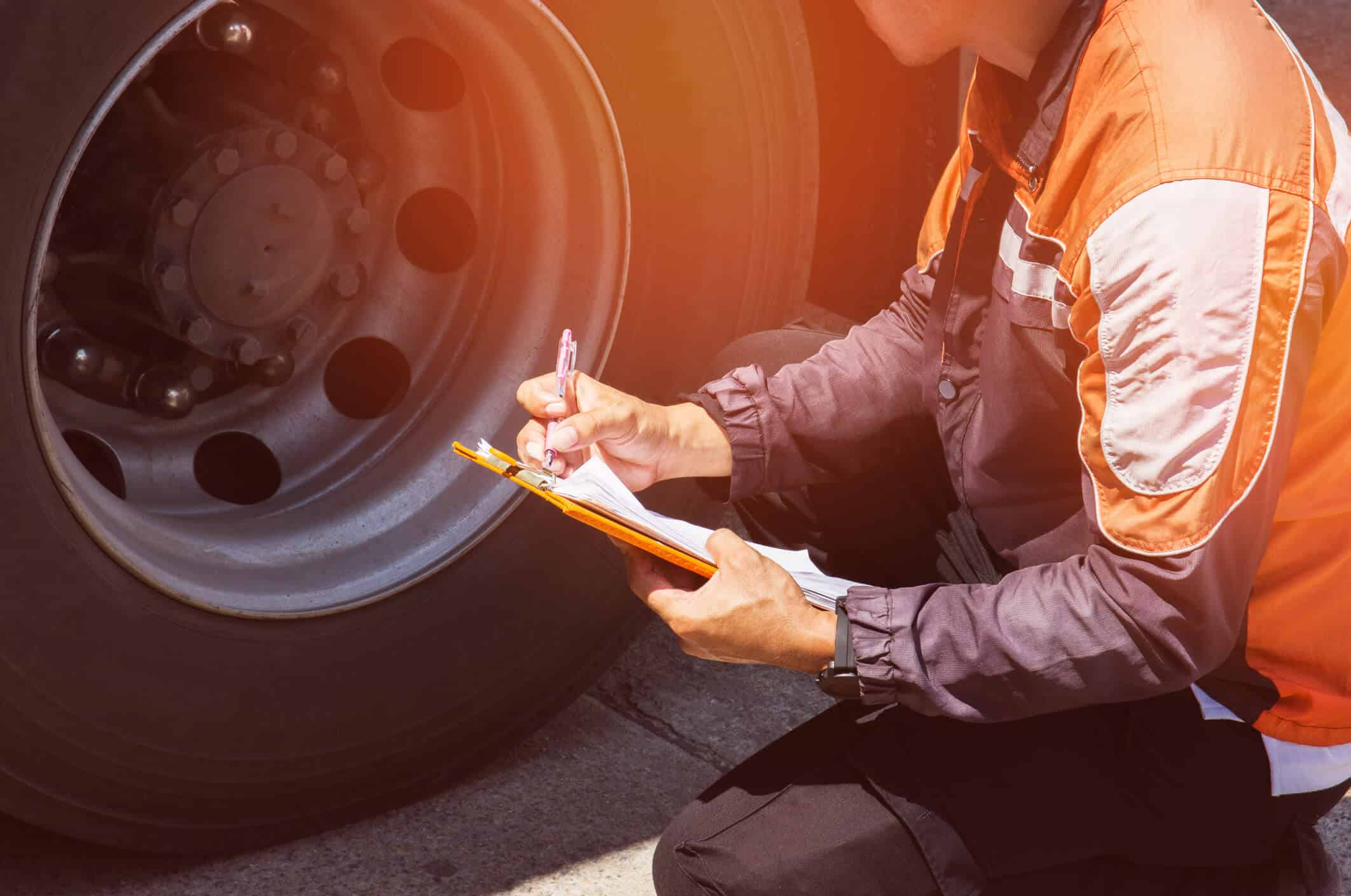 worker inspecting tires