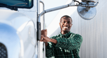 smiling driver with semi truck