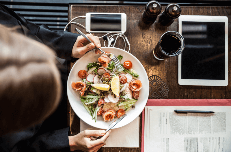 lady eating salad at a table