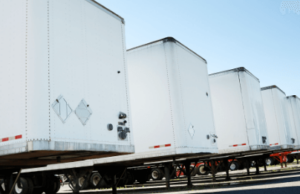 back end of semi truck trailers in a line