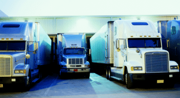 three semi trucks parked