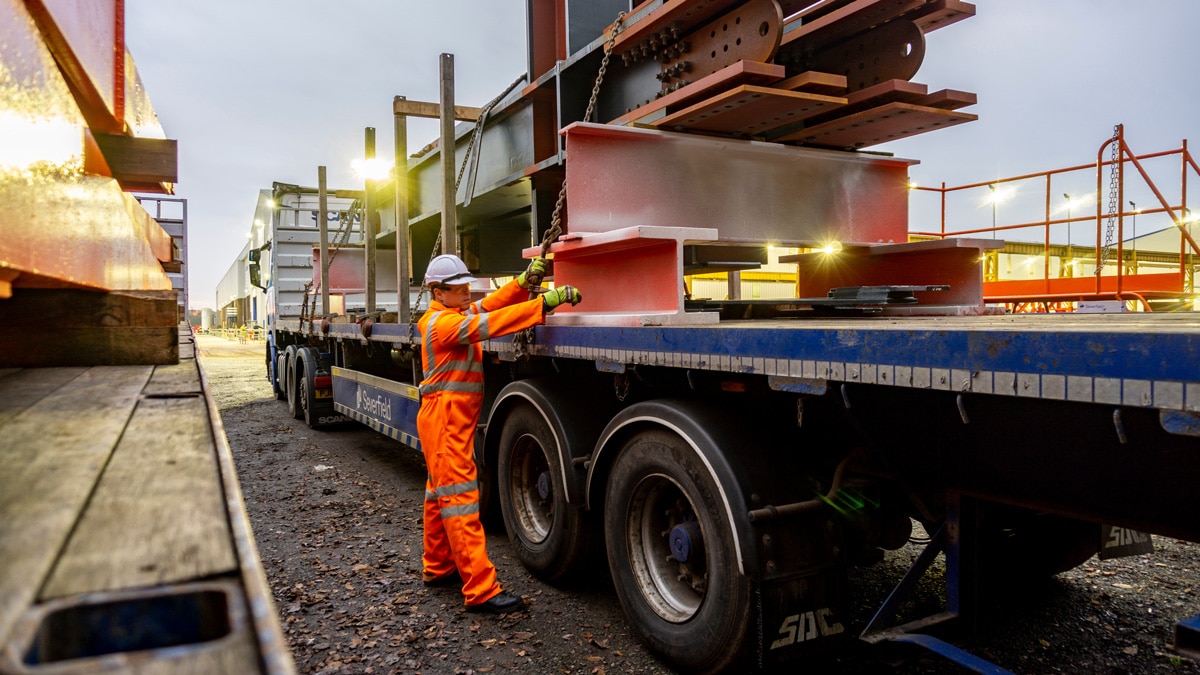 Capstone employee putting items on a flatbed