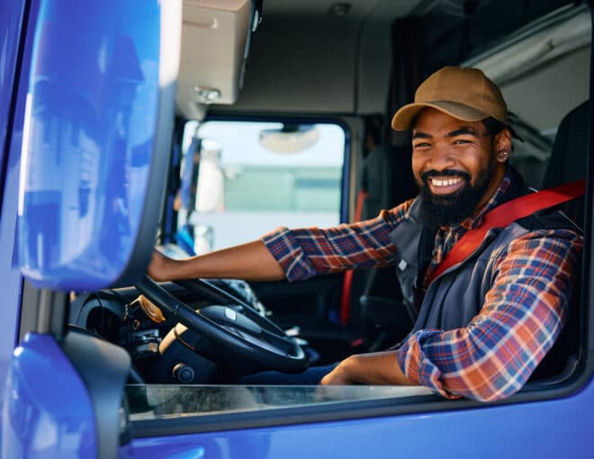 smiling freight driver in a truck