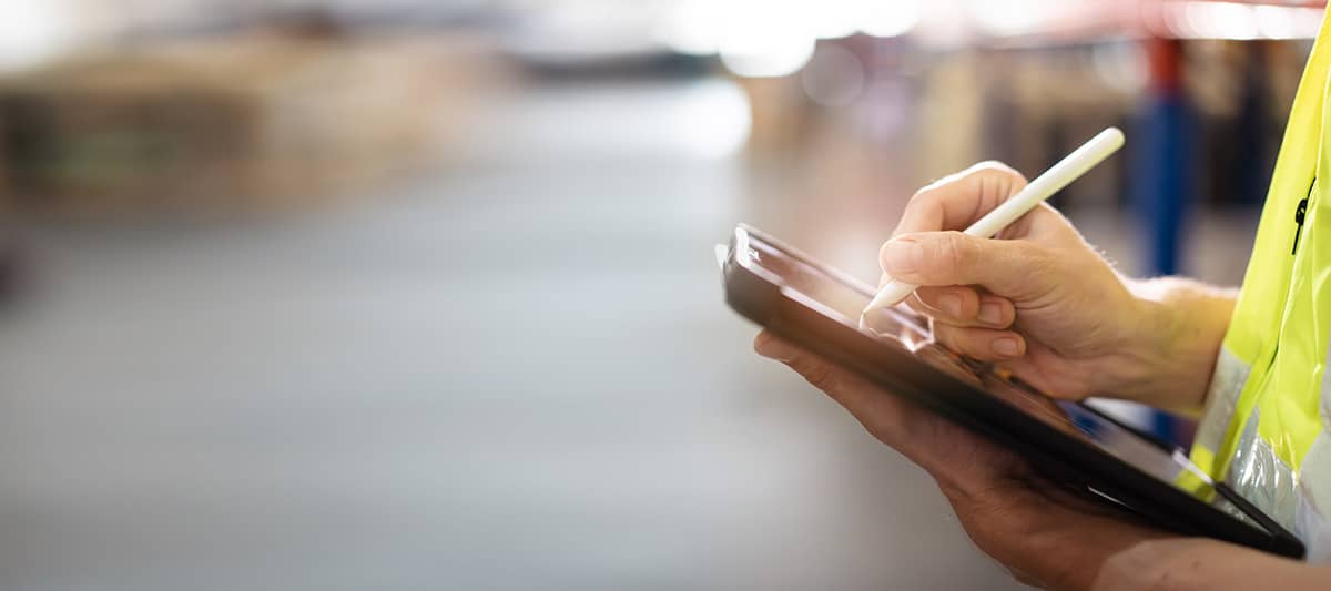 Warehouse worker using a tablet for inventory management