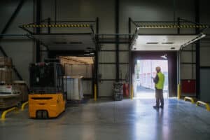 a warehouse worker overseeing the storing of delivered items