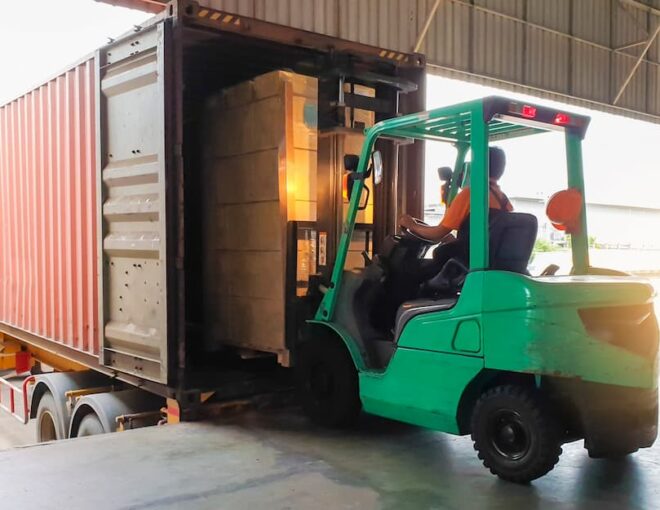 warehouse lumpers unloading truck in dock