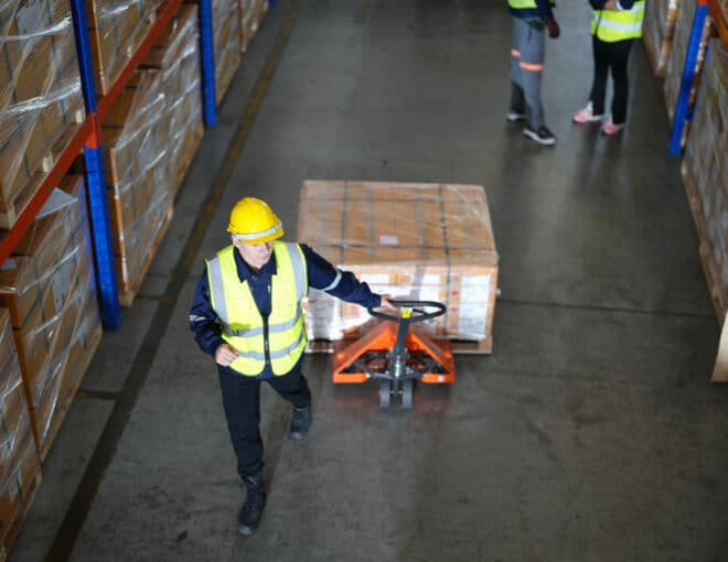 warehouse worker unloading in a distribution center