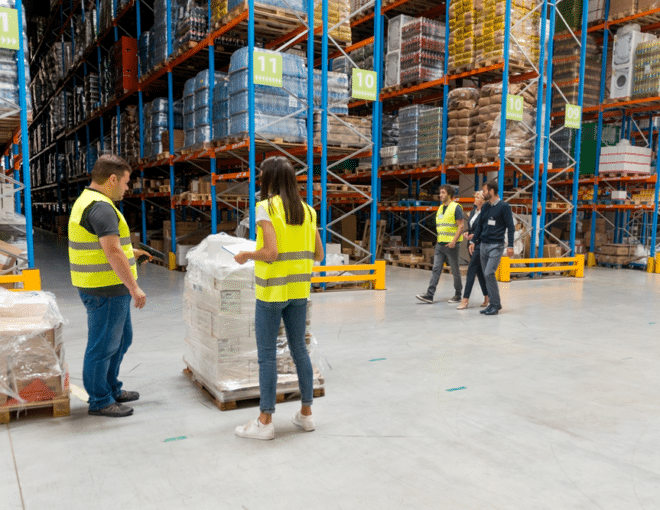 managers and workers on the warehouse floor