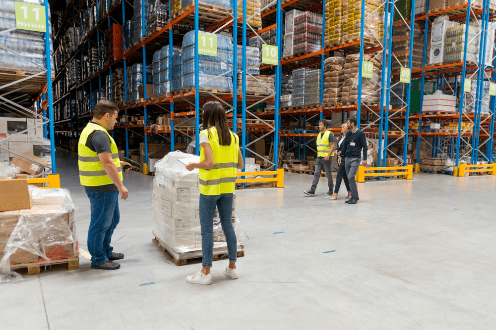 managers and workers on the warehouse floor