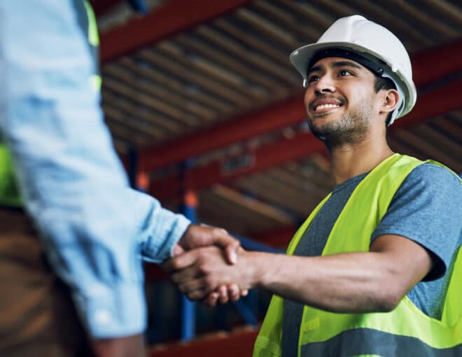 warehouse working shaking hands with another worker