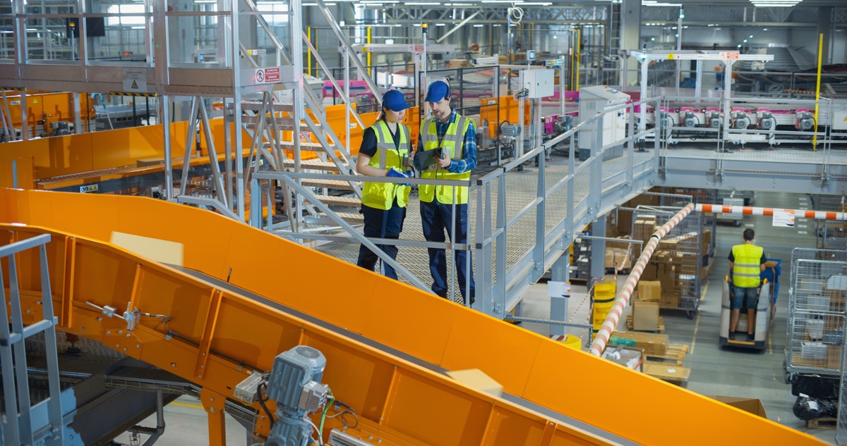 warehouse associates diagnosing automation and conveyor belts