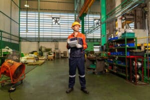 warehouse worker with industrial fans in the heat