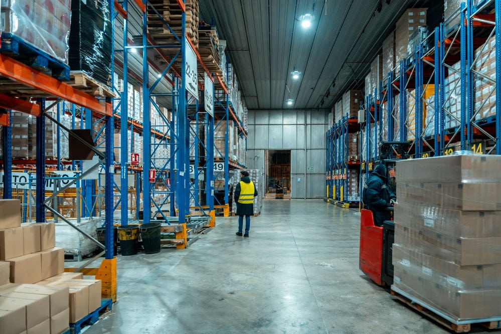 Warehouse associate moving inventory during a warehouse relocation at a distribution center